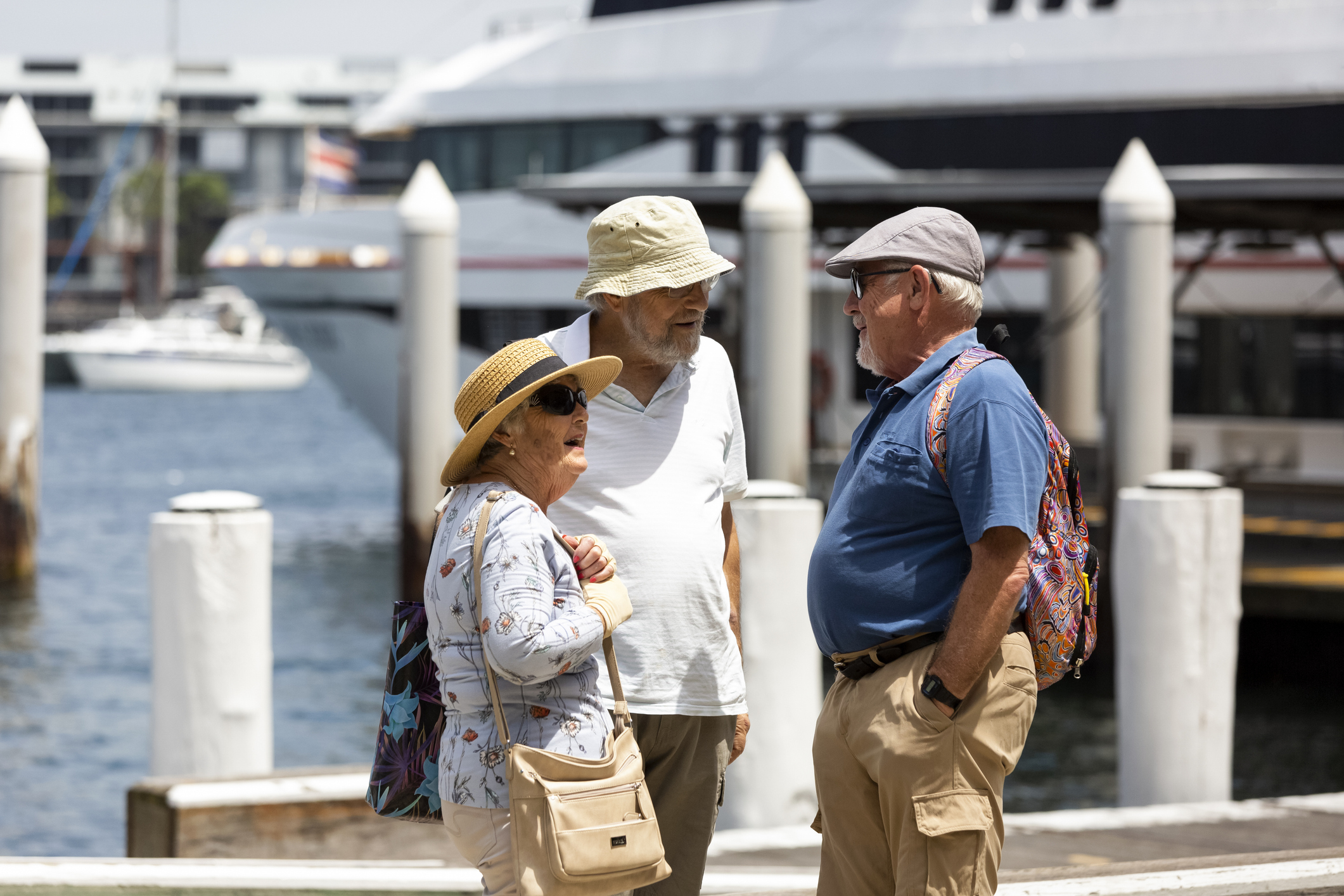 Three seniors talking in city waterfront, copy space